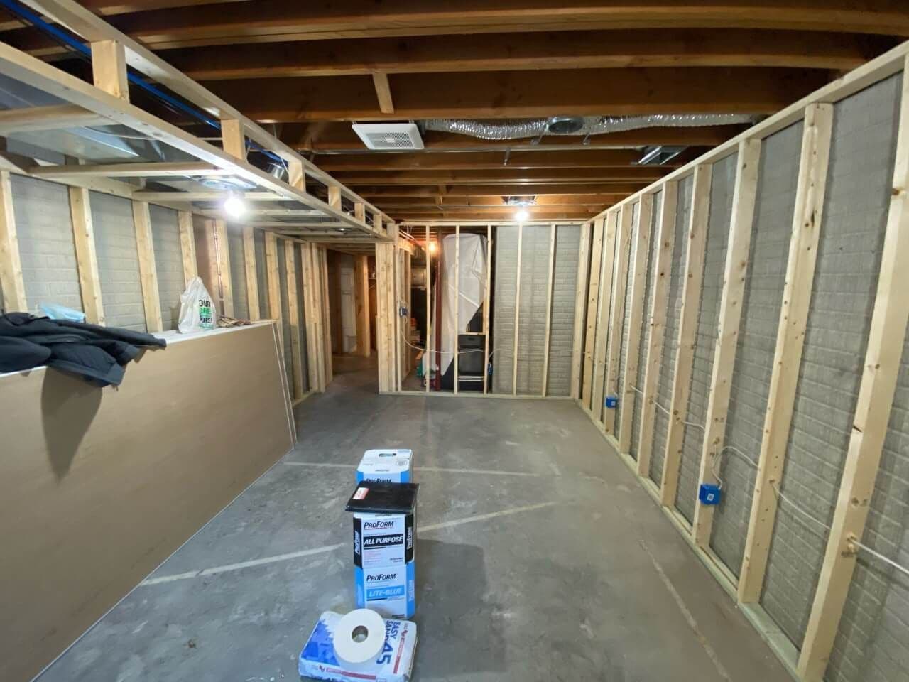 wide shot of new wooden framing for walls and ceiling of basement