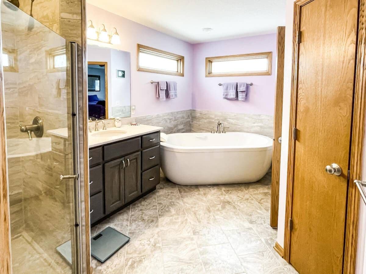 full photo shot of a bathroom shower, sink, tub, and closets