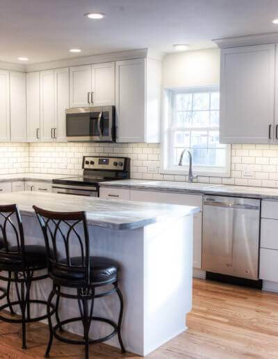 kitchen counter top with white and gray marbling and a subway tile backsplash