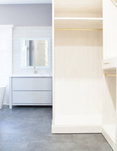walk-in closest with custom built-in drawers and clothes hanging