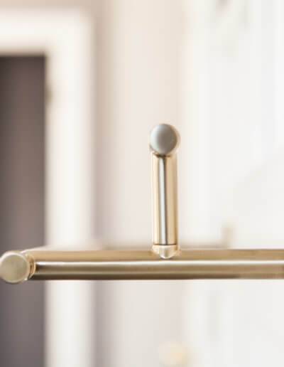 close up side view of a brass towel rack