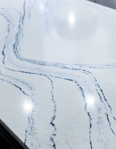 close up image of white countertop on kitchen island with navy blue marbling
