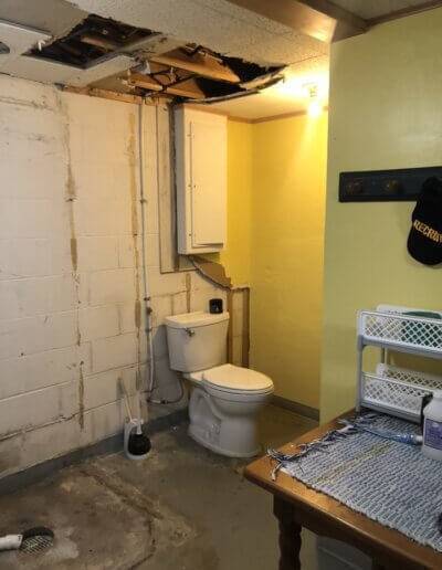 toilet in corner of old basement