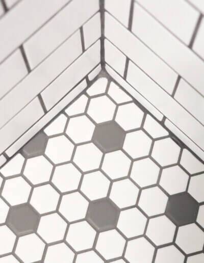 close up of black and white ornate subway tile corner