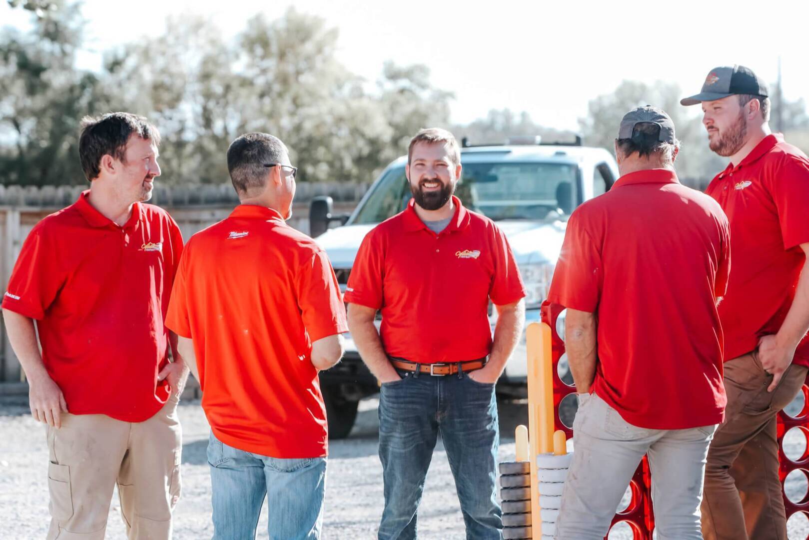 Five Cyclone Contracting employees chat at an employee event.