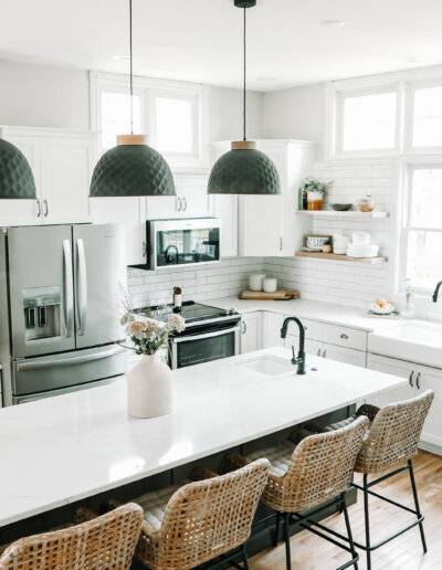 Overview of bright and neutral tones kitchen with pendant lights